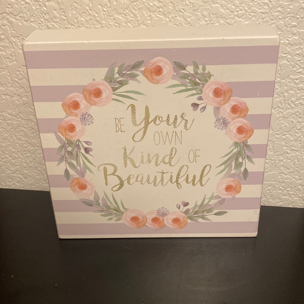A cute sign saying be your own kind of beautiful. Has hints of pastel colors.